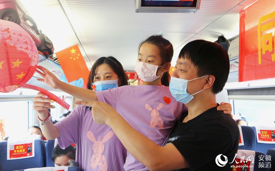 G649次列車上，旅客一家三口在車上內賞花燈、猜燈謎。梁浩然 攝
