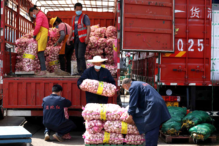 在安徽省合肥市周谷堆大興農產品物流園蔬菜交易中心，工人在搬運蔬菜。解琛攝