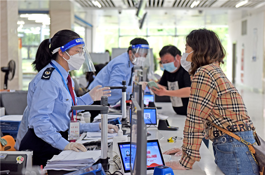 2022年4月25日，安徽省淮南市政務服務大廳稅務窗口，稅務工作人員為企業辦理涉稅業務，助力企業復工復產。陳彬攝