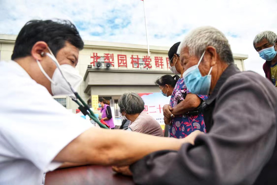 醫生正用聽診器為村裡老人聽診。謝家集區委宣傳部供圖