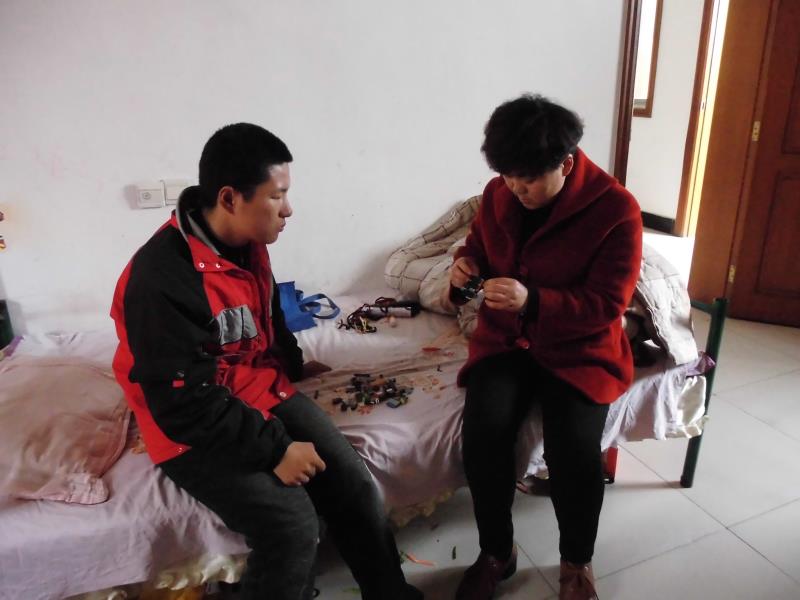 王荣照顾脑瘫的大儿子。卢旭供图