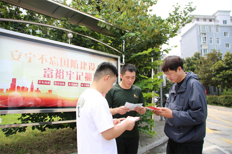亳州高新区第五社区管理中心军服站站长武兴国(中间)在社区介绍退役军人优待证办理政策。张重摄