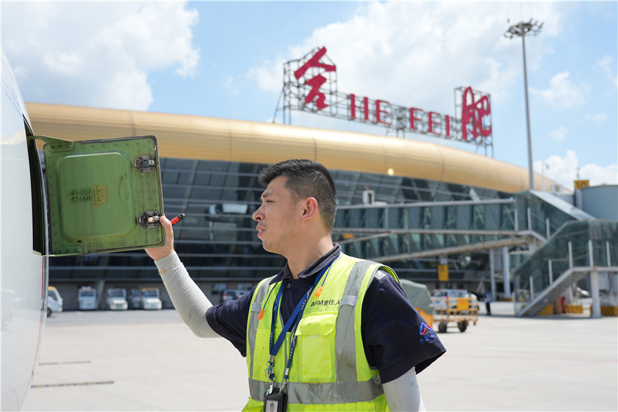 合肥新桥国际机场内工作人员正在对飞机进行检测。管大龙摄
