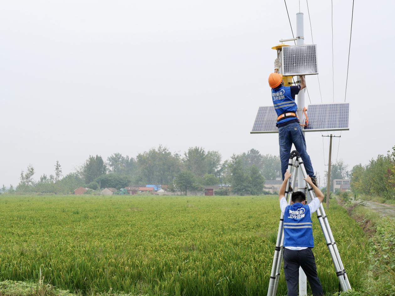 中國電信技術人員正在巡檢殺虫燈和監控設備