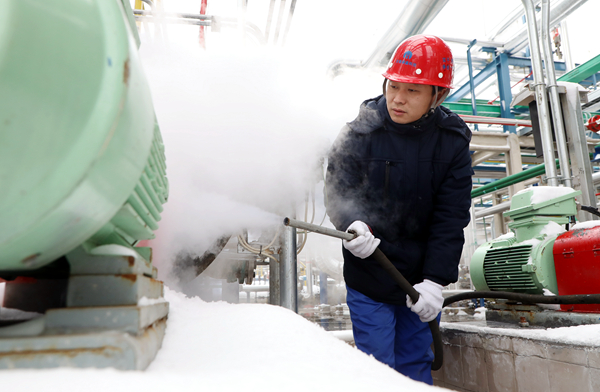 碳鑫科技一名职工用蒸汽为设备除雪除冰，保障设备运行正常。王明明摄