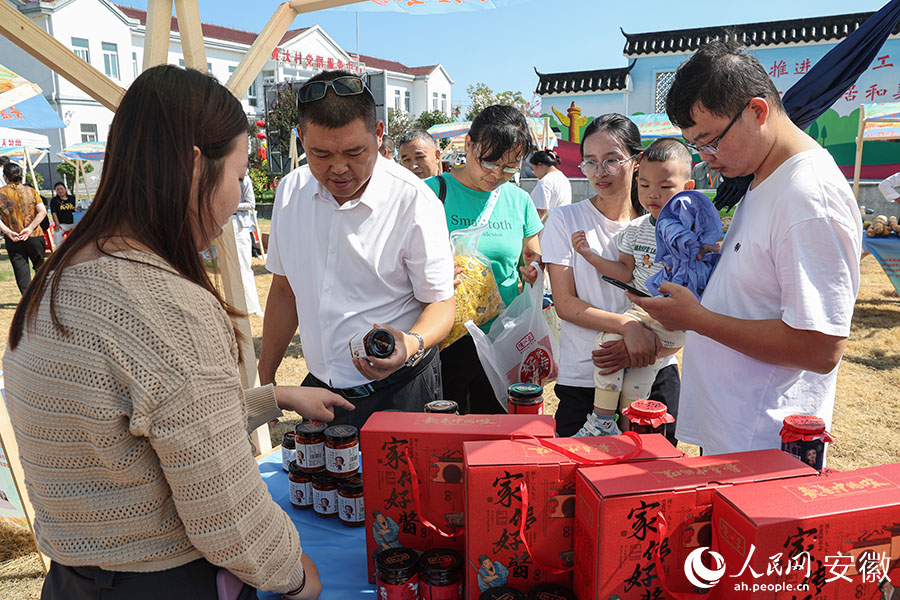 安徽无为，市民在丰收集市上采购商品。人民网记者 张俊摄