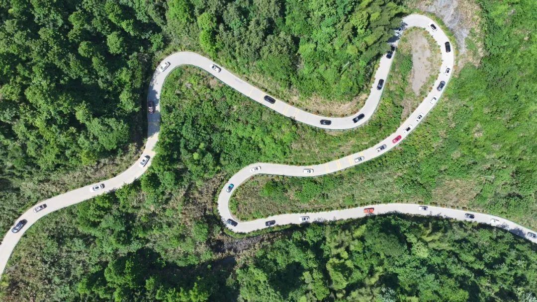 百車自駕在蜿蜒山道上。馮傳學攝