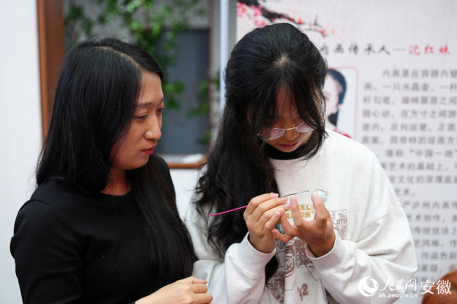 学生在非遗代表性传承人的指导下体验庐州内画。人民网记者 苗子健摄