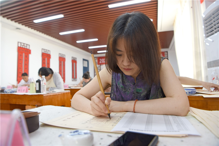 安徽淮南师范学院师生书法爱好者用毛笔为2025年录取新生手写录取通知书。