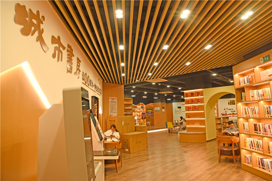 安徽省淮南市田家庵区市民利用晚间休息时间在家门口的城市书房中享受阅读。