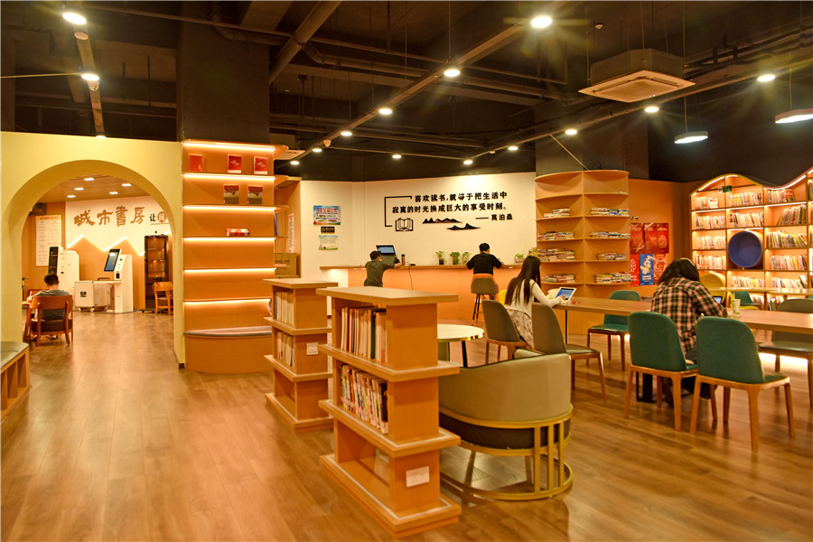 安徽省淮南市田家庵区市民利用晚间休息时间在家门口的城市书房中享受阅读。