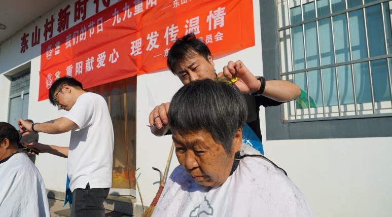 理发师们为老人修剪发型。