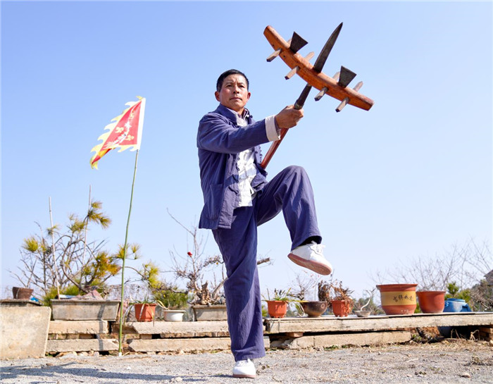 谢卫信挥半耙展现东乡武术刚劲招式。