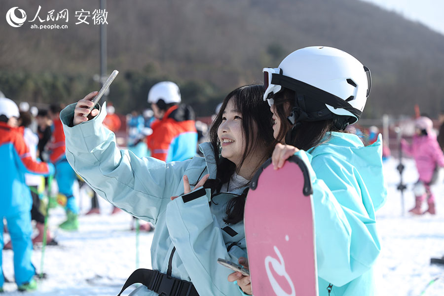 游人在雪道边“打卡”拍照。人民网记者 陶涛摄