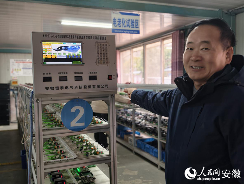 吴雪峰指着自动化检测设备介绍。人民网 陶伟摄