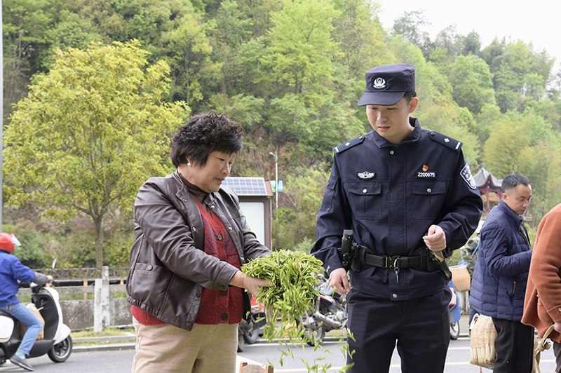 民警葛胤彤正在走访镇上的茶农。陈苏杭摄