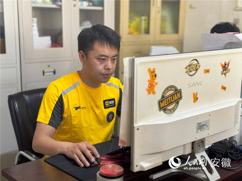 代冬祺在站点处理工作调度。人民网记者 吕欢欢摄
