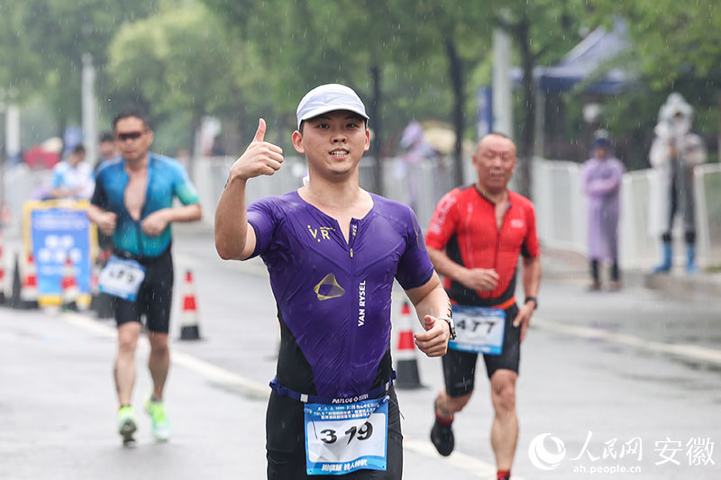 雨中奔跑，选手给自己点赞。人民网记者 张俊摄