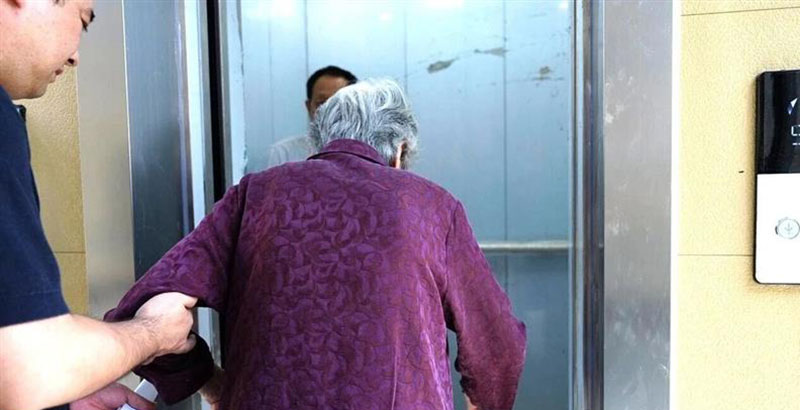 阜南县中医院家属院居民乘坐加装电梯。