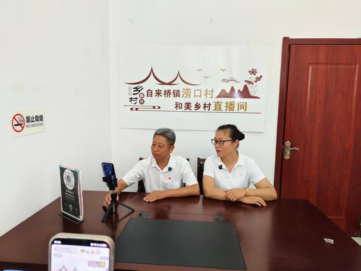涝口村党总支书记王庭玖与村干部开播解读民生政策。张皖妮摄