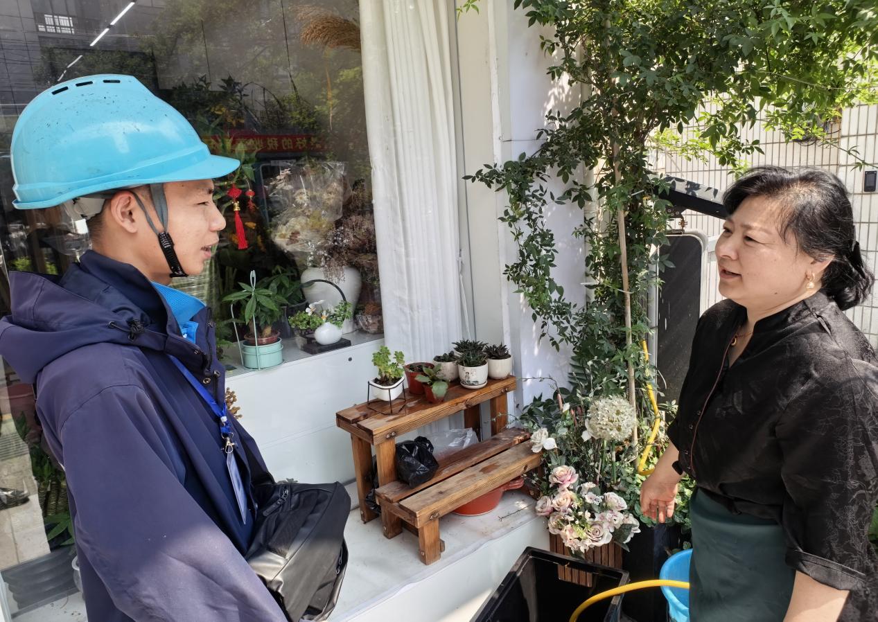 花店老板王阿姨向爱家工程师胡睿表示感谢。