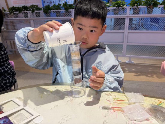 小读者在新华书店亳州伊顿庄园店聚精会神参加实验活动